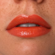 Bestiale Flirt Lip Oil – coral swatch on lips